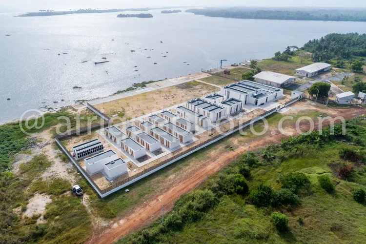 Africa photo — Vue aérienne d’une résidence moderne en bord de lac avec plusieurs bâtiments blancs alignés, entourés de végétation et d’un chemin de t